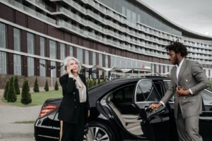 Limousine chauffeur opening a Car Door for a Woman passinger